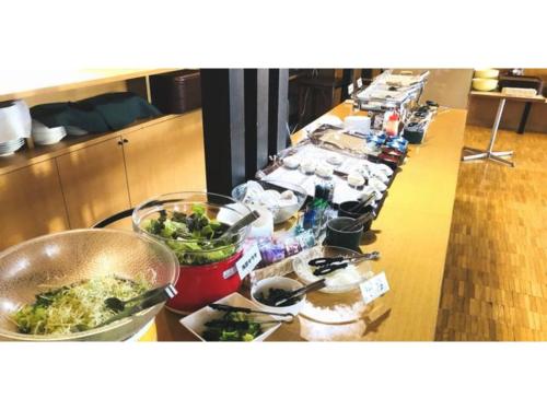 a long buffet line with plates and bowls of food at Smile Hotel Tomakomai - Vacation STAY 68949v in Tomakomai