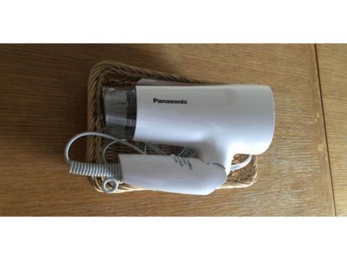a hair dryer in a basket on a table at Smile Hotel Tomakomai - Vacation STAY 68911v in Tomakomai