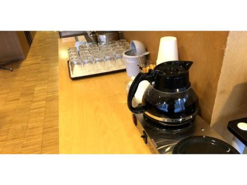 a black coffee pot sitting on top of a stove at Smile Hotel Tomakomai - Vacation STAY 68926v in Tomakomai