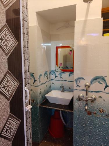 a bathroom with a sink and a mirror at Tanubithi Resort in Bolpur