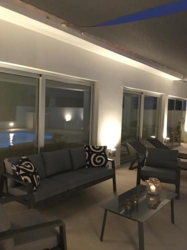 a living room with a couch and a table at Katikies Grand in Pissouri