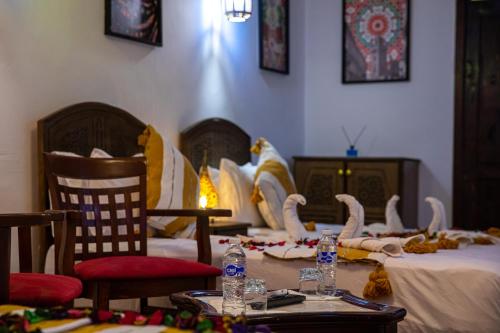 a room with a table with swans on it at Riad Hikaya - Fes Story in Fès
