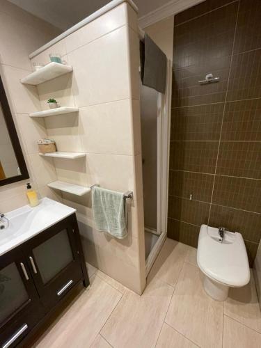 a bathroom with a toilet and a sink at Balcón al mar in Adra