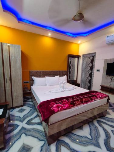 a bedroom with a large bed with flowers on it at Tanubithi Resort in Bolpur