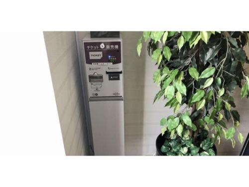 a machine is next to a potted plant at Smile Hotel Tomakomai - Vacation STAY 68926v in Tomakomai