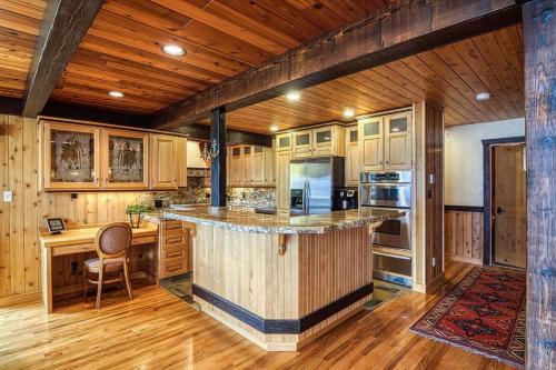 a kitchen with a large island in the middle of it at Mountain Retreat, Panoramic Lake Views in Invermere