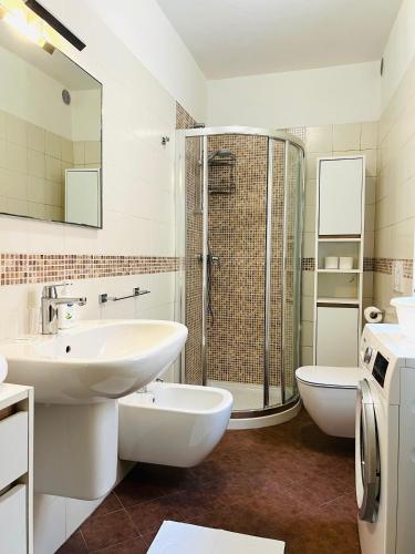 a white bathroom with a sink and a shower at Welcome Traveller Residenza Salier in Garda