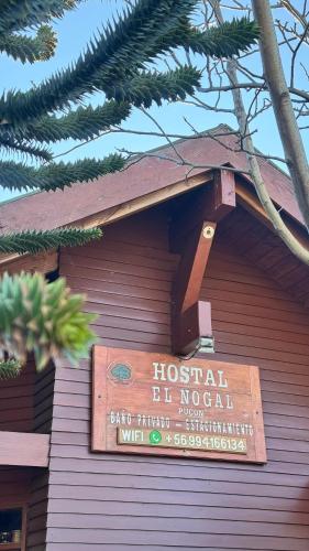 a sign on the side of a building at Hostal el Nogal Pucón in Pucón