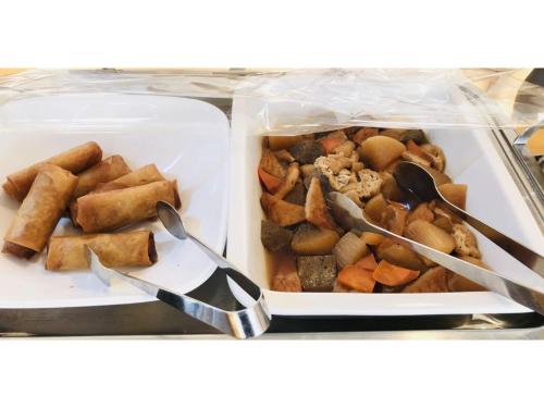 a plastic container of food with two spoons and foodfacts at Smile Hotel Tomakomai - Vacation STAY 68943v in Tomakomai