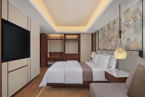 a hotel room with a bed and a flat screen tv at The Westin Resort Nusa Dua, Bali in Nusa Dua