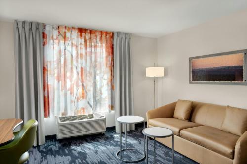 a living room with a couch and a window at Fairfield Inn & Suites by Marriott Cincinnati Uptown/University Area in Cincinnati