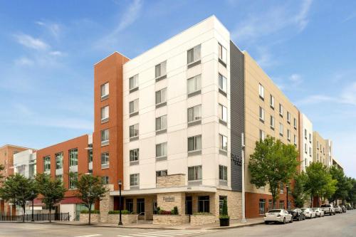 an apartment building with a white facade on a street at Fairfield Inn & Suites by Marriott Cincinnati Uptown/University Area in Cincinnati