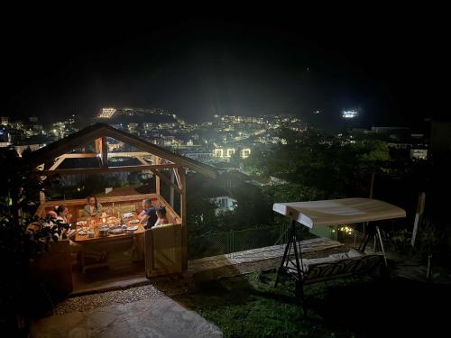 a group of people sitting at a restaurant at night at Нощувки "Феникс" in Devin