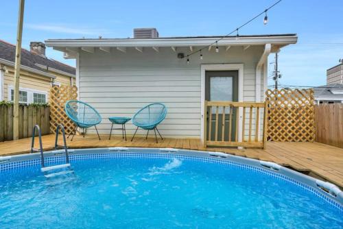 a swimming pool with two chairs and a house at Mid-City 3BR w Pool Balcony Near Streetcar & FQ in New Orleans