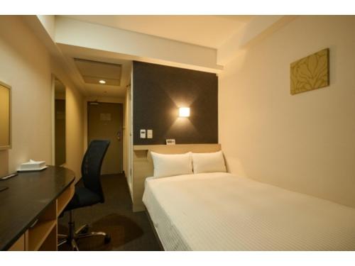 a hotel room with a bed and a desk at Smile Hotel Kyoto Shijo - Vacation STAY 69790v in Kyoto