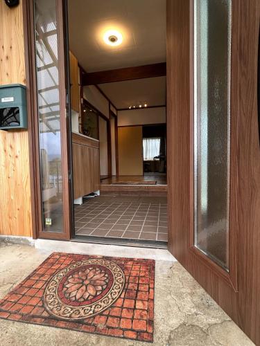 an entrance to a building with a rug on the front door at 8co - Vacation STAY 69979v in Chino