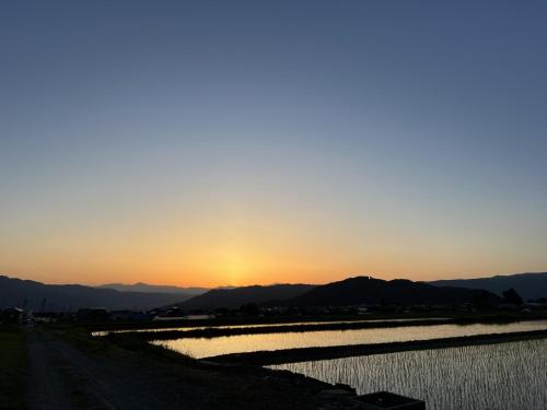 a sunset over a river with mountains in the background at 8co - Vacation STAY 69979v in Chino