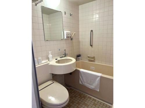 a bathroom with a sink and a toilet and a tub at Smile Hotel Nabari - Vacation STAY 70536v in Nabari