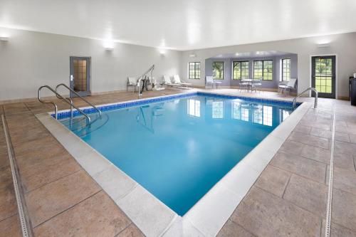 a large swimming pool with blue water at Staybridge Suites Harrisburg-Hershey by IHG in Harrisburg
