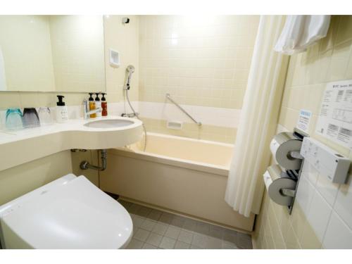a bathroom with a toilet and a tub and a sink at HOTEL enoe Hakodate - Vacation STAY 78528v in Hakodate