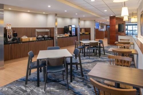a waiting area with tables and chairs in a cafeteria at Fairfield Inn & Suites by Marriott Santa Cruz in Santa Cruz