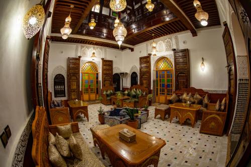 a view of a living room with a large room at Riad Hikaya - Fes Story in Fès