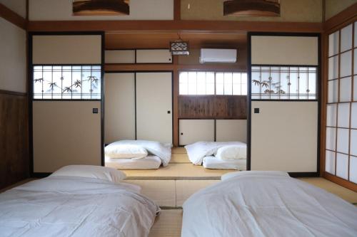 Ένα ή περισσότερα κρεβάτια σε δωμάτιο στο Japanese Villa Mihatacho - Vacation STAY 71709v