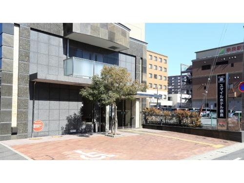 a building with a tree in the middle of a street at Smile Hotel Nara - Vacation STAY 73732v in Nara