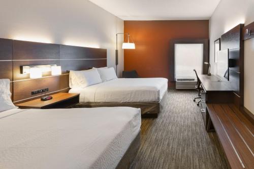a hotel room with two beds and a desk at Holiday Inn Express Hotel & Suites Blythewood by IHG in Blythewood