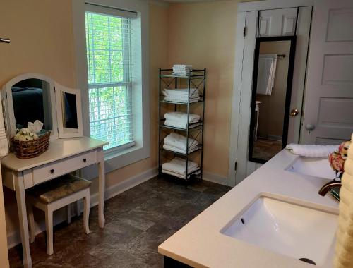 a bathroom with a sink and a mirror at Downtown Cary 1930s Bungalow - Great walkability in Cary