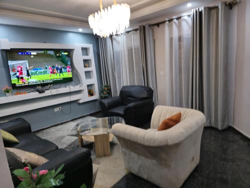 a living room with a couch and a tv at Siewoue BTP sarl in Mfou