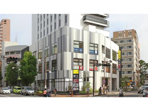 a large building on a city street with cars at Smile Hotel Shonan Fujisawa - Vacation STAY 74510v in Fujisawa