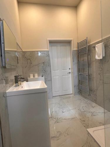 a bathroom with a sink and a shower at Deans Residence in Edinburgh