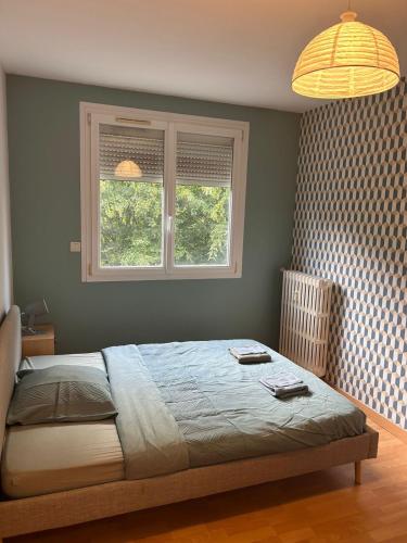 a bedroom with a bed and a window and a lamp at Spacious, bright 4 bedroom, 80 m2 in Hérouville-Saint-Clair