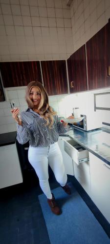 a woman standing in a kitchen with her hands on a counter at Cuba linda, alojamiento en cápsulas in Asuncion
