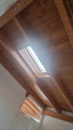 a wooden ceiling with a window in a room at B&B Sud Salento in Alessano