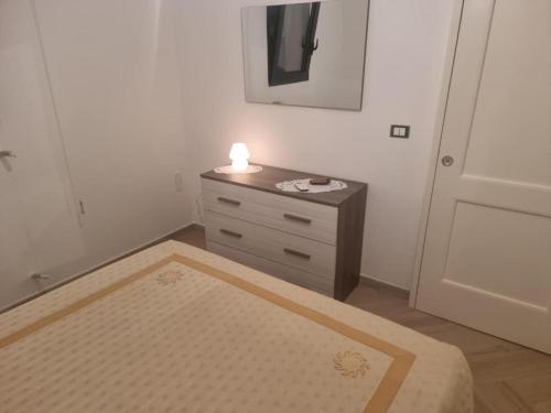 a room with a bed and a nightstand with a light at B&B Sud Salento in Alessano