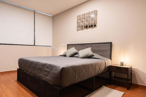 a bedroom with a large bed in a room at 307 Spacious AC apt Historic CDMX Rooftop in Mexico City