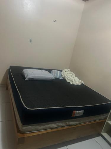 a bed in a room with a black mattress at Casa Maria in Belém