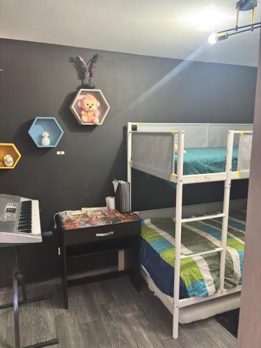 a bedroom with two bunk beds and a desk at Departamento a 5 minutos del Estadio GNP in Mexico City