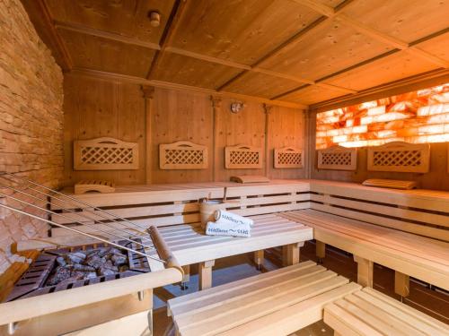 a sauna with benches and a stove in it at Ferienhof Oblasser in Mayrhofen