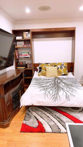 a bedroom with a bed and a desk and a television at Chalet At The Beach in Seguin 