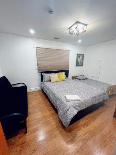 a bedroom with a bed and a chair in it at Chalet At The Beach in Seguin 