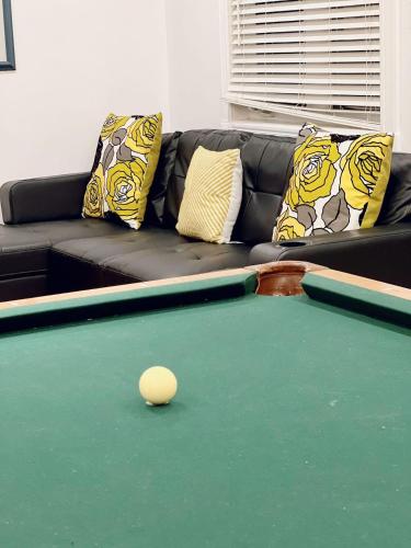 a living room with a pool table and a couch at Chalet At The Beach in Seguin 