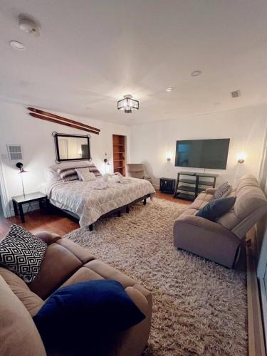 a bedroom with a bed and a flat screen tv at Chalet At The Beach in Seguin 