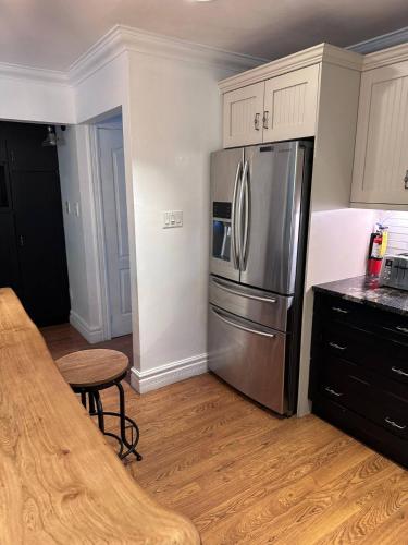 a kitchen with a stainless steel refrigerator and a table at Chalet At The Beach in Seguin 