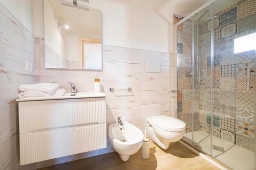 a bathroom with a toilet and a sink and a shower at Il Belvedere di Babbo in Fasano