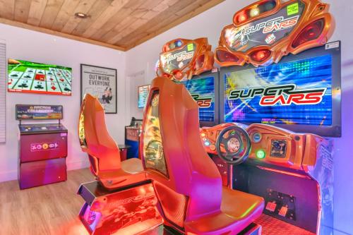 a room with arcade games and video games at Family Chalet With Rooftop Theater GameRoom Mins to DT in Gatlinburg