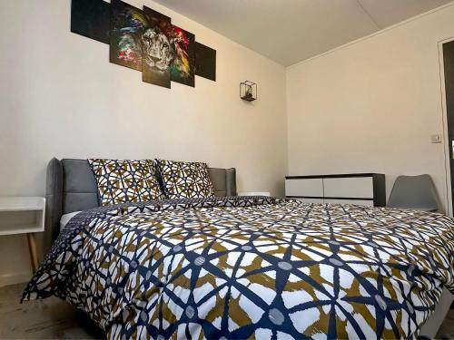 a bedroom with a bed and pictures on the wall at T3 spacieux et lumineux in Châteauroux