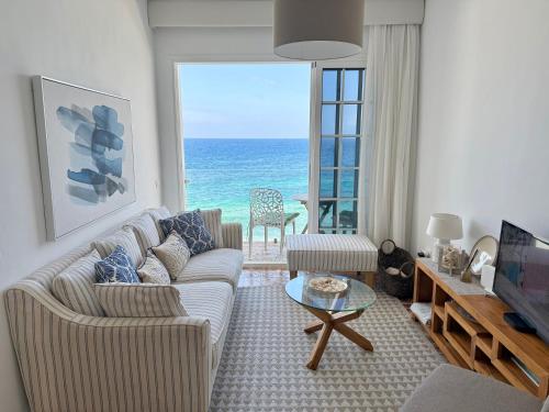 a living room with a couch and a view of the ocean at Casa Ale, Stunning Sea Views in Las Aguas
